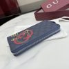 Interlocking double G and stirrup prints embellish various small leather items, showcasing festive colors. This pattern is eye-catching and embellished on this fully zippered wallet made of soft GG Supreme